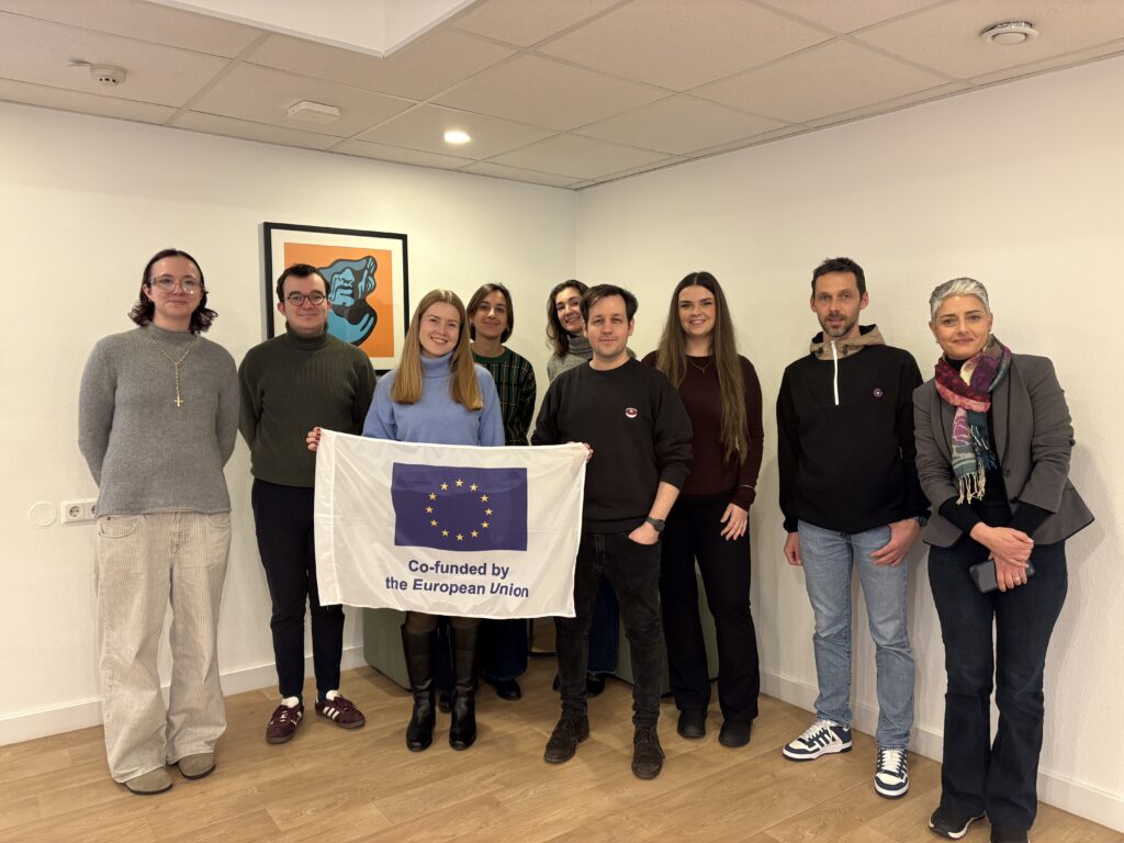 Kick-off Meeting in Vienna, Austria - picture of partners holding Co-funded by the European Union flag